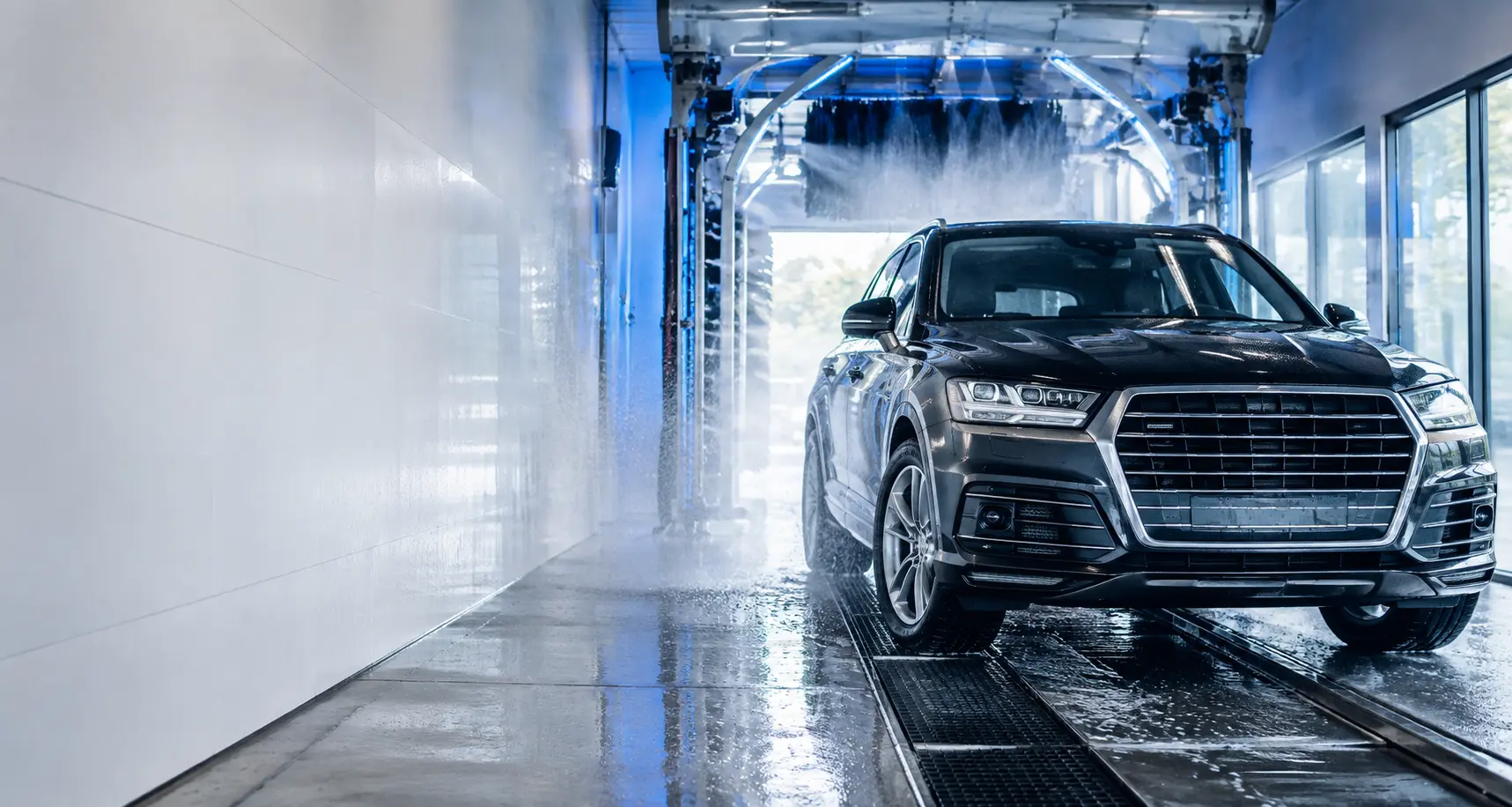 SUV moving through a modern car wash