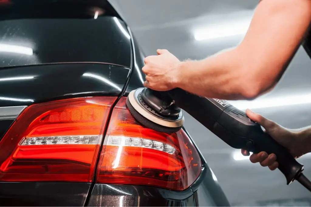 A Cruzin detailing specialist polishing a vehicle finish